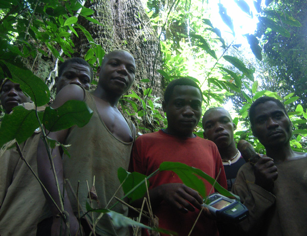 1 A group of young Congalese men in a forest, one with a handheld device