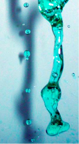 Blue liquid falling in a stream