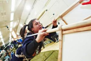 Woman flies an ancient contraption in a zero gravity flight